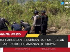 Aparat Gabungan Bersihkan Barikade Jalan Saat Patroli Keamanan di Dogiyai
